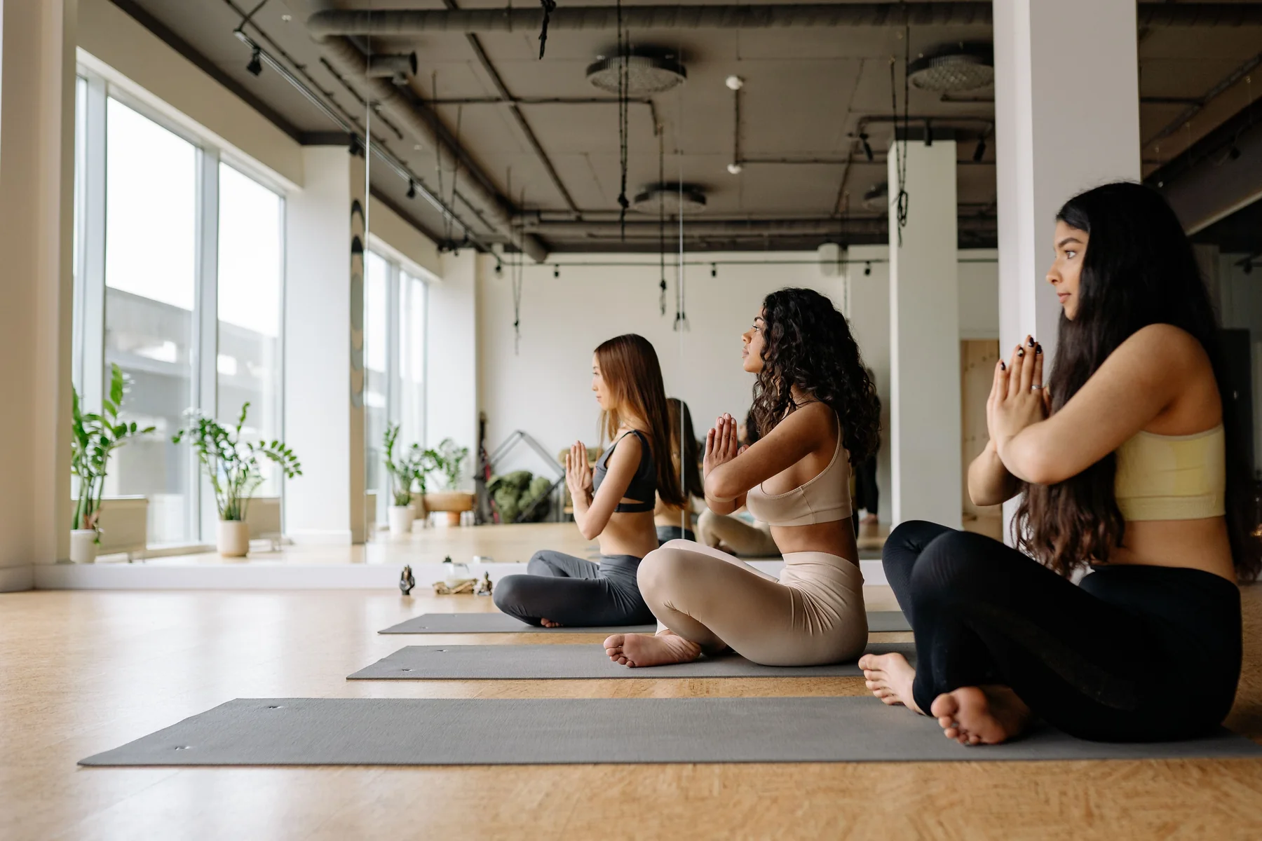 Three students seated in a calm meditation practice